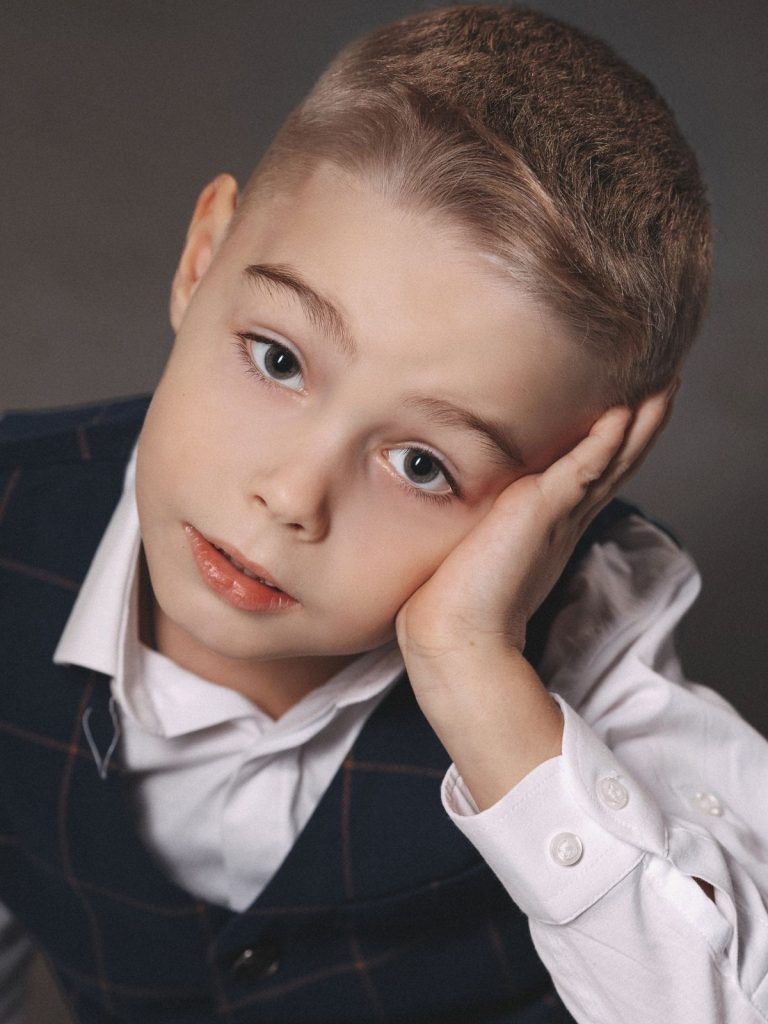 Young boy with a classic crew cut, short tapered sides and a blended top